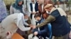 An Afghan health worker administers polio drops to a child during a polio vaccination campaign in Nangarhar Province, Afghanistan, November 2021.